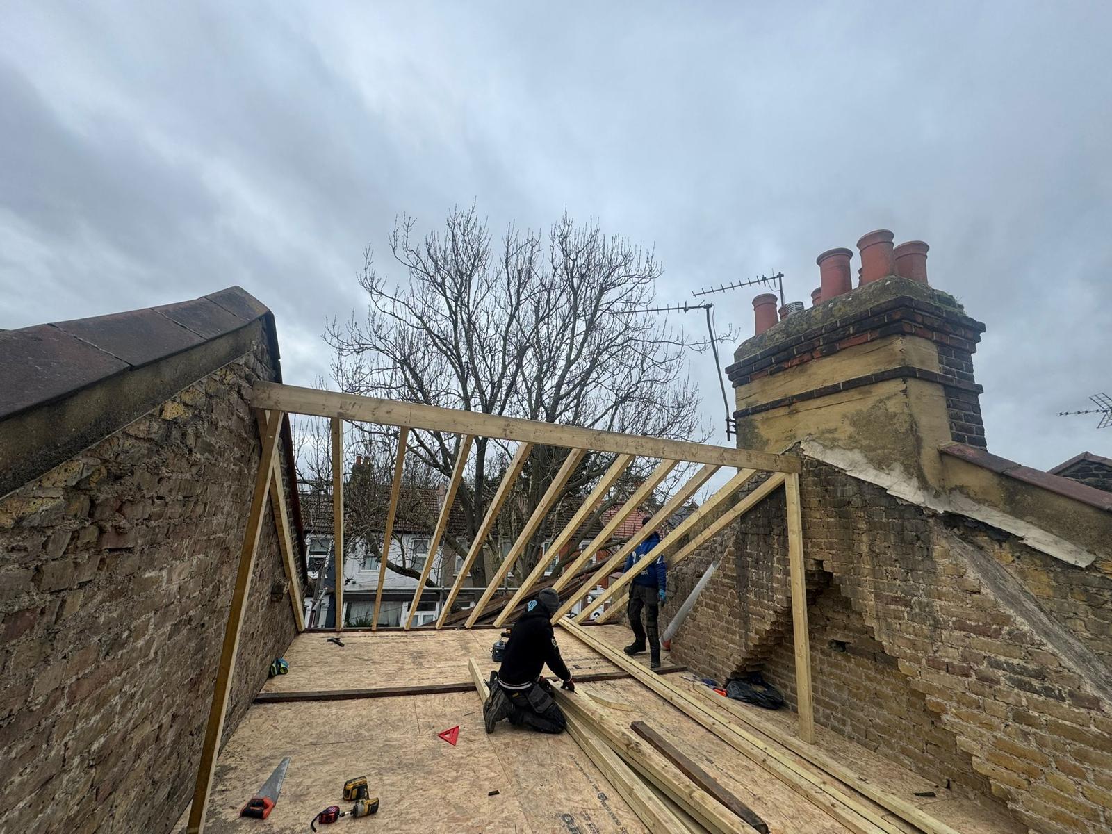 Apex UK Roofing team building a new roof structure